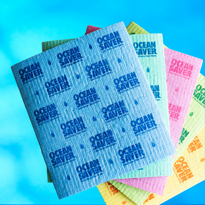 Biodegradable sponge cloths fanned out on a blue background