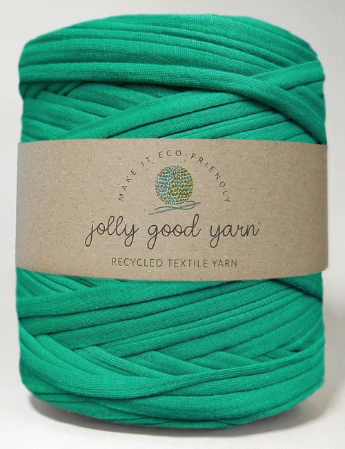 Red yarn ball with a beige label on a white background