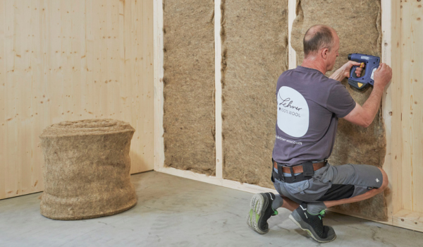 Sheep wool insulation being installed