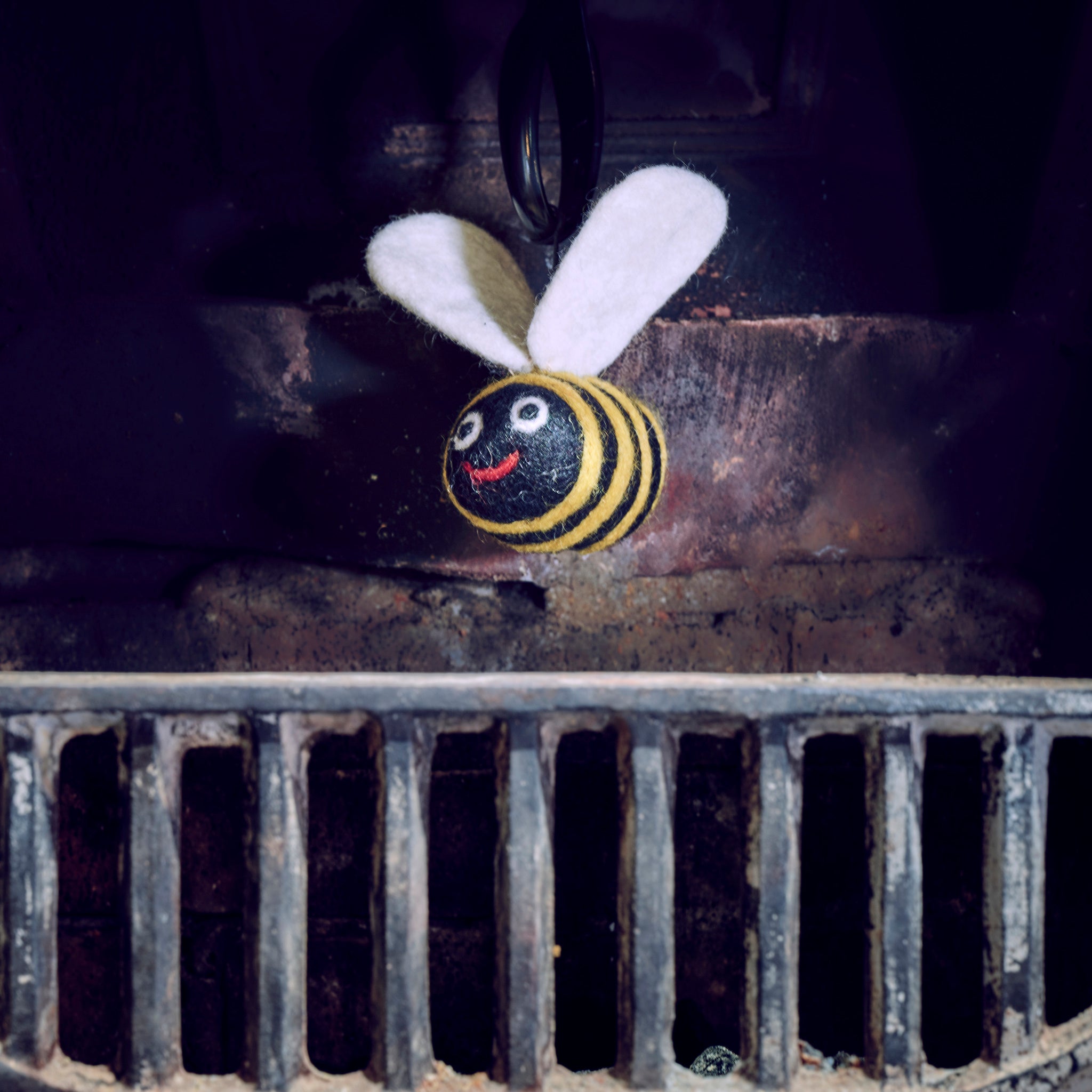 woolly felted bee dangle in fireplace