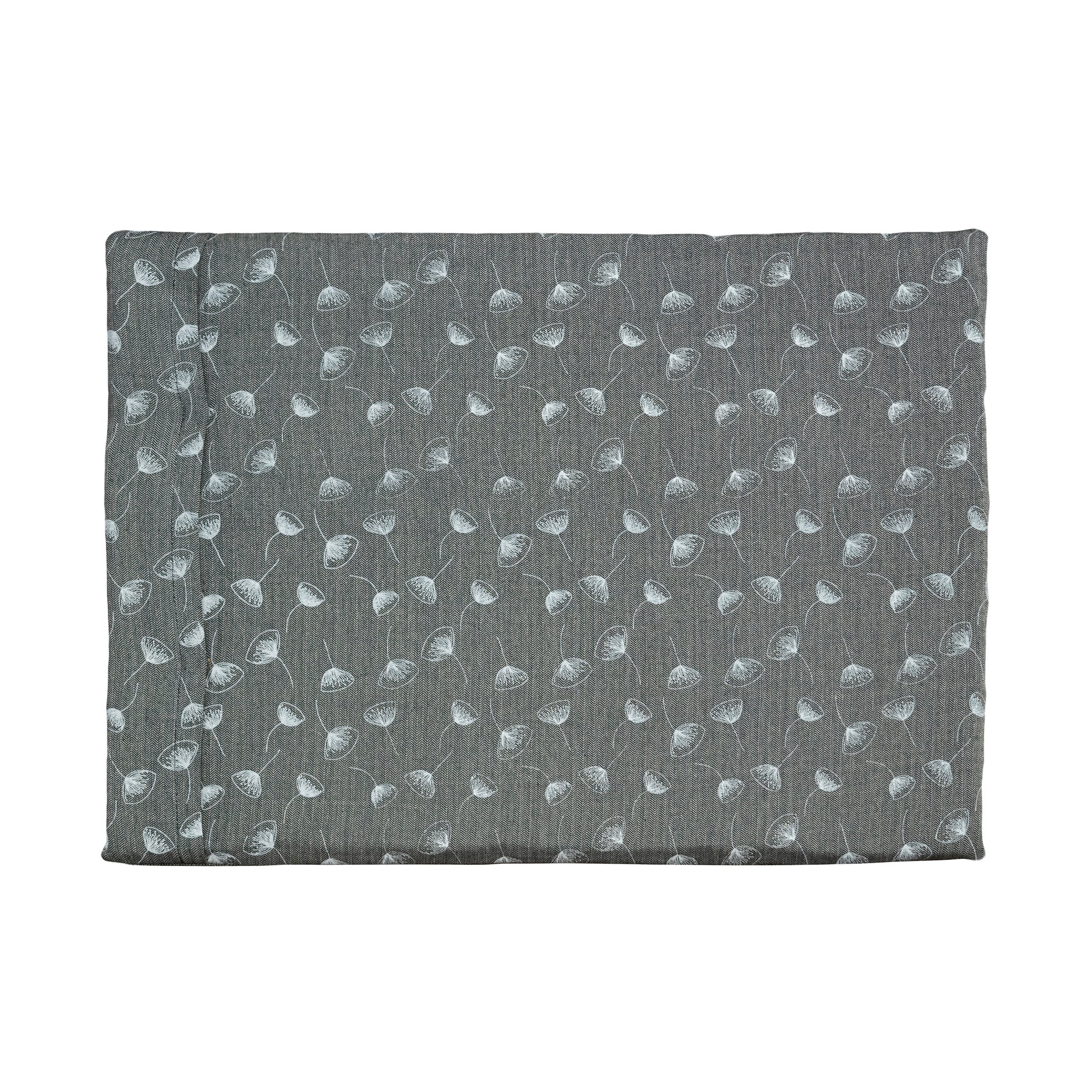 A Chimney Sheep Luxury felted wool dog bed. The bed is large and rectangular. This luxury wool dog bed is placed onto a white background. The organic cotton cover is patterned. The pattern is grey-blue with white flowers.