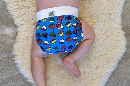 Hybrid eco nappy with compostable liner and blue resuable cotton pant