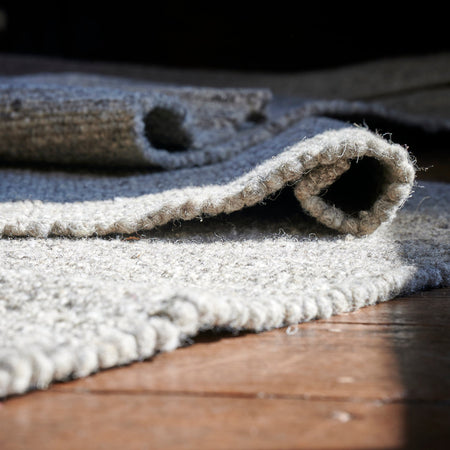 Handwoven T'Yan wool rug made from Herdwick and Texel fleeces, displayed in a living room setting