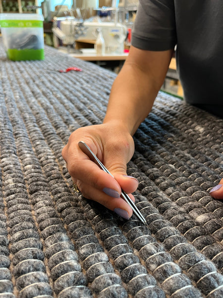 Handwoven British wool rug being checked