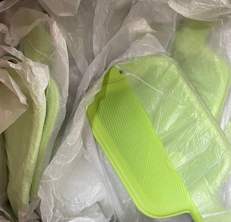 box of bright green fairtrade rubber water bottles wrapped in white tissue paper