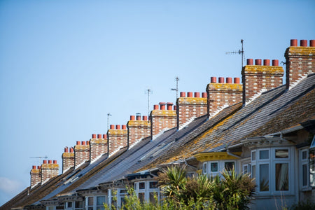 Row of terraced seaside houses with multiple chimneys