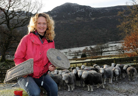 Sally Phillips - Green Hero holding Chimney Sheep infront of Herdwick Sheep