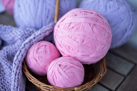 Pink and mauve T-Shirt Yarn being used for knitting project 