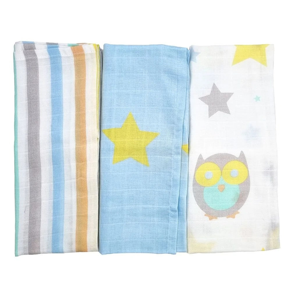 60cm muslins folded down, lying next to each other to show different designs. One stripey, one blue with yellow stars, and one with owls on