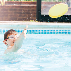 child in pool with plastic free frisbee thumbnail