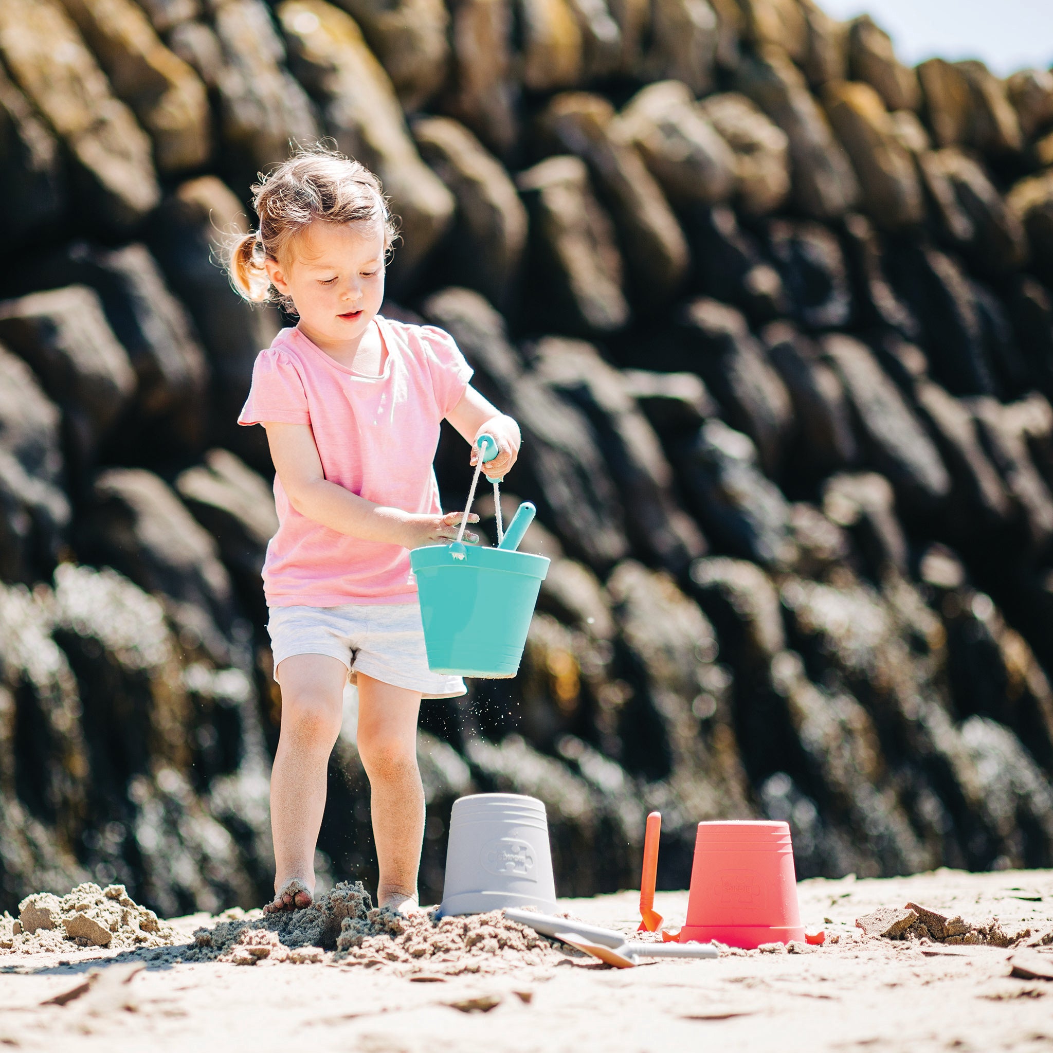 Girl with plastic free bucket and spade