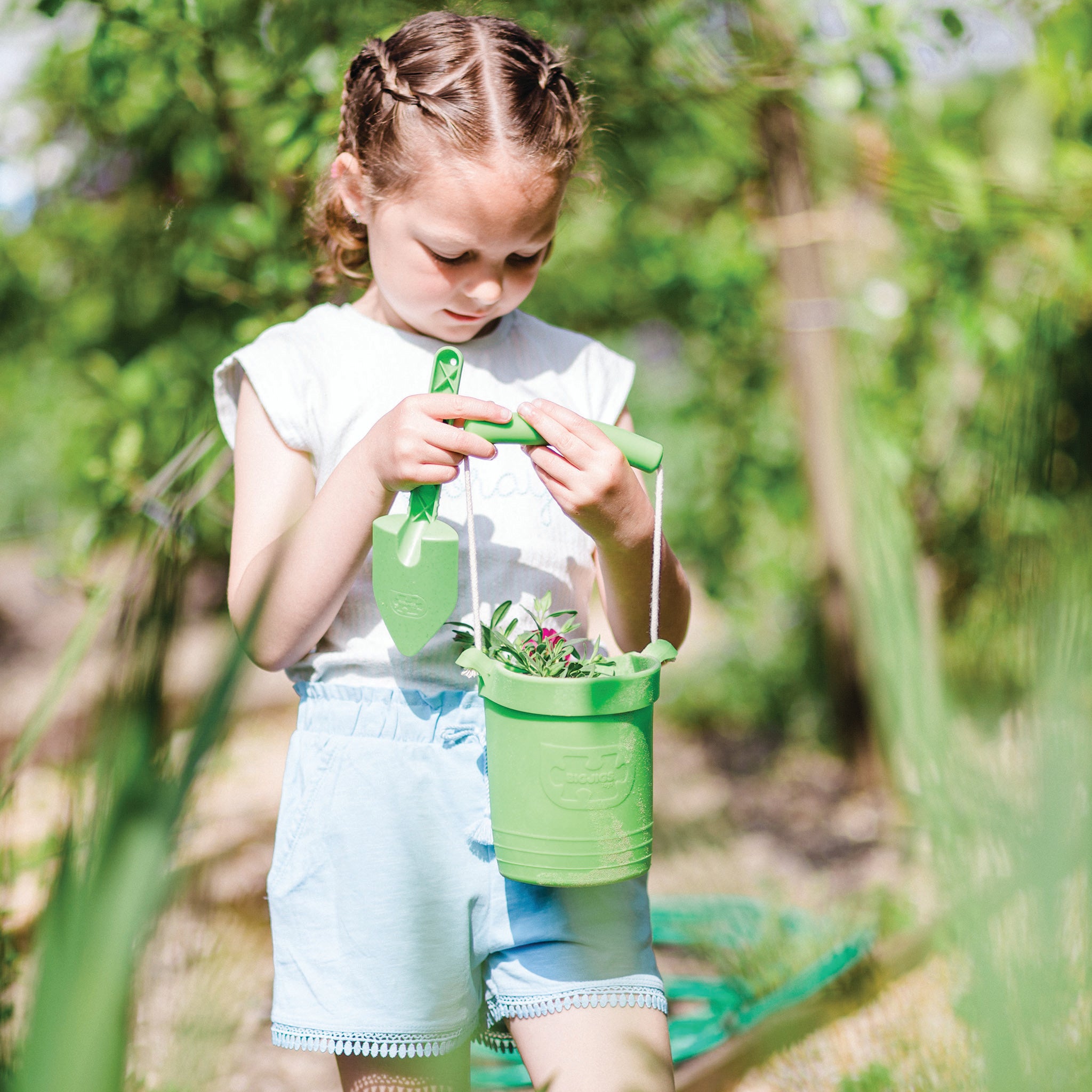 Girl with plastic free bucket and spade
