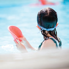 child in pool with plastic free frisbee thumbnail