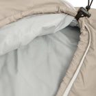 Close-up of a beige insulated sleeping bag with a light grey interior lining, white zipper trim, and a black plastic zipper pull on a white background.