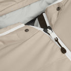 Close-up of a beige puffer jacket showing the front zipper, snap buttons, and a light grey inner lining.
