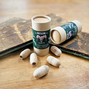 Nutscene handcrafted wooden acorn cane toppers scattered on a wooden table