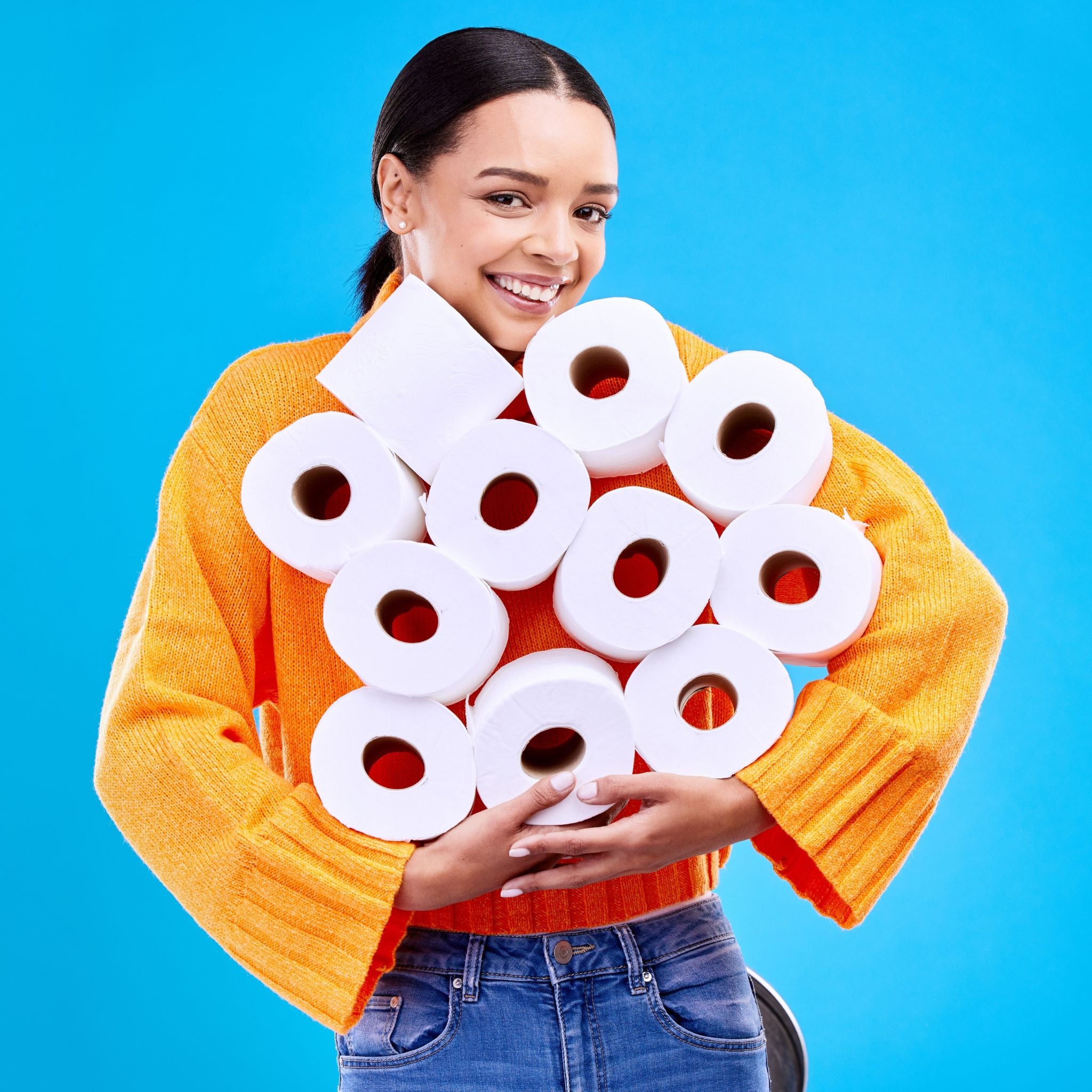 Lady with an armful of 100% recycled toilet paper rolls 