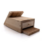 A wooden bat box lay down on a white background