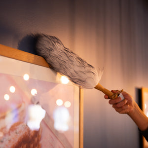 Lambswool duster with solid beechwood handle dusting the top of a picture frame