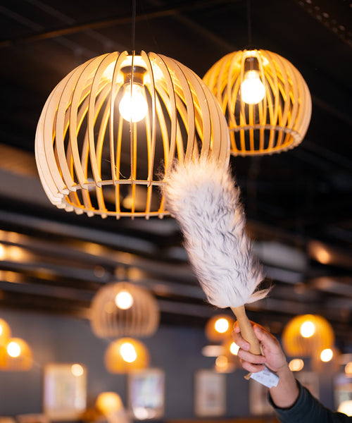 Lambswool duster with solid beechwood handle dusting the top of a picture frame