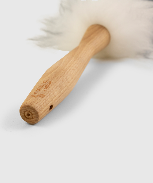 Lambswool duster with solid beechwood handle dusting the top of a picture frame