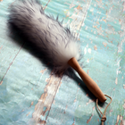 Lambswool duster with a solid beechwood handle on a textured blue surface
