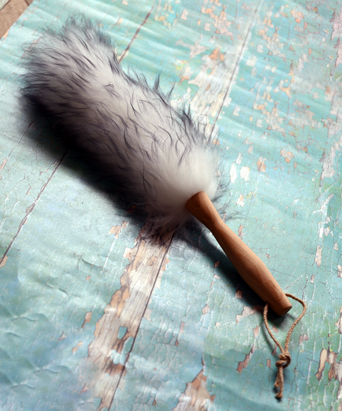 Lambswool duster with solid beechwood handle dusting the top of a picture frame
