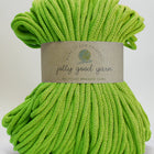 Green knitting cord made from recycled materials with a white background