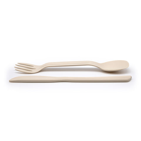 Eco-friendly spork and knife laid out on a white background.