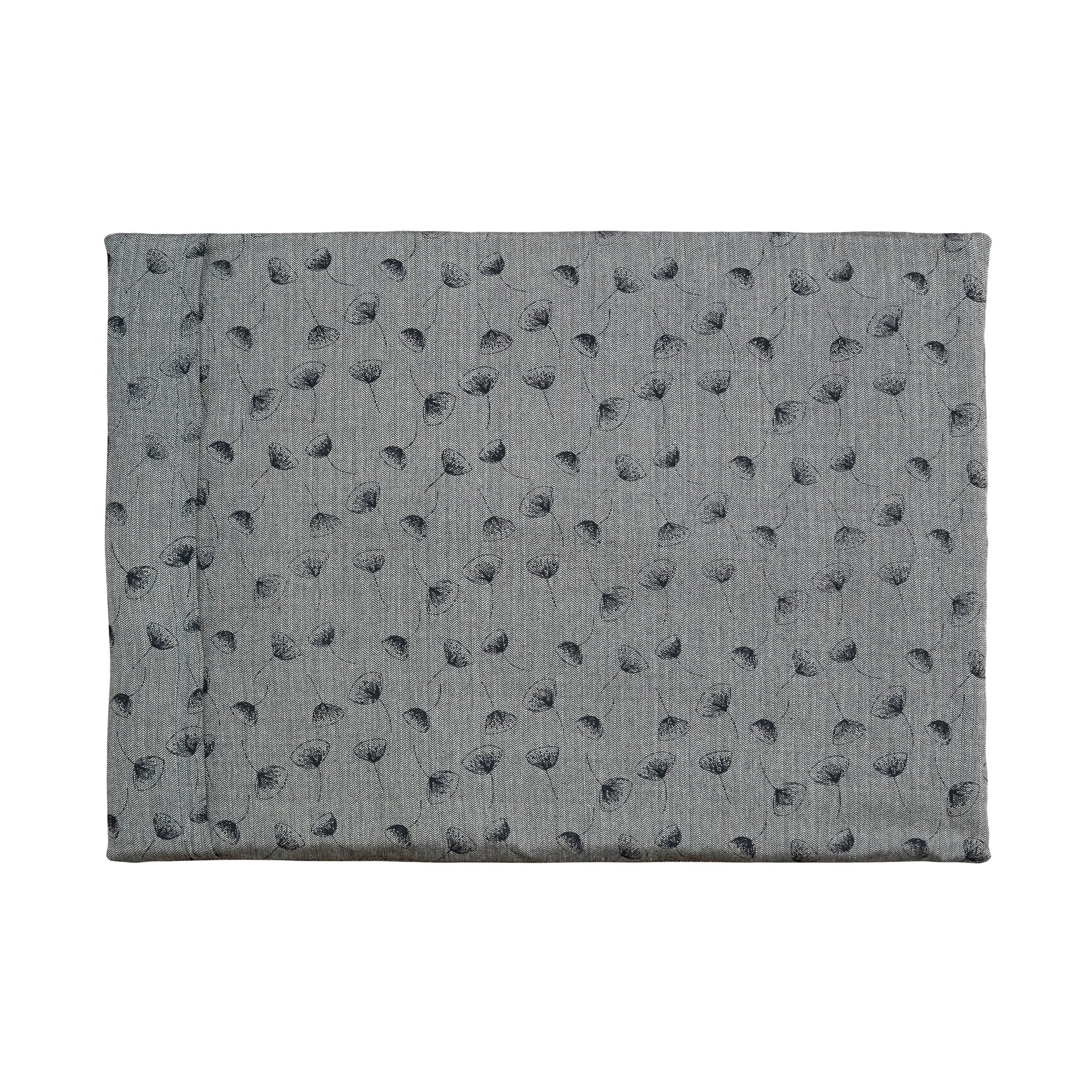 A Chimney Sheep Luxury felted wool dog bed. The bed is large and rectangular. This luxury wool dog bed is placed onto a white background. The organic cotton cover is patterned. The pattern is grey with black flowers