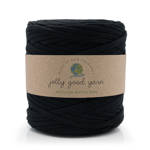 A skein of deep blue recycled textile yarn wrapped in a brown kraft paper label that reads 'jolly good yarn'.