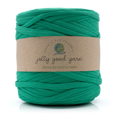 A skein of deep blue recycled textile yarn wrapped in a brown kraft paper label that reads 'jolly good yarn'.
