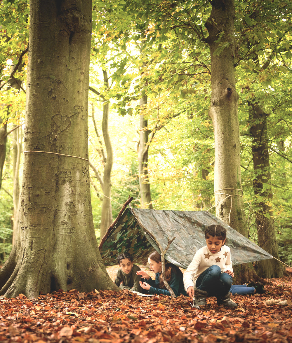 children with den in woods
