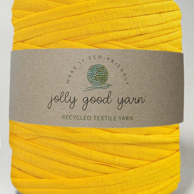 Red yarn ball with a beige label on a white background