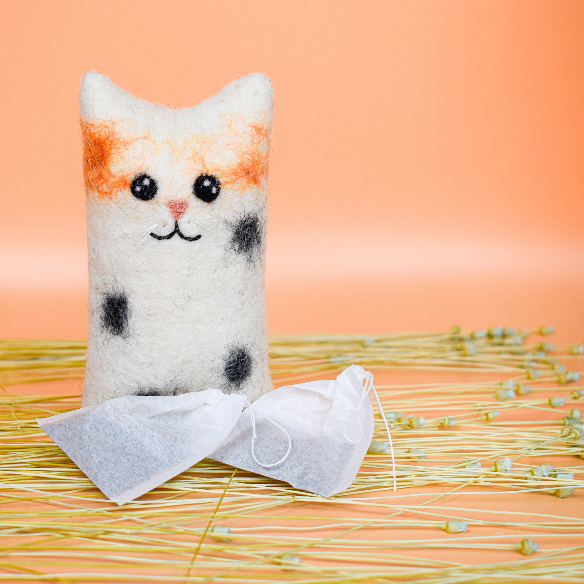 small white hooman's friend cat toy made of felted wool