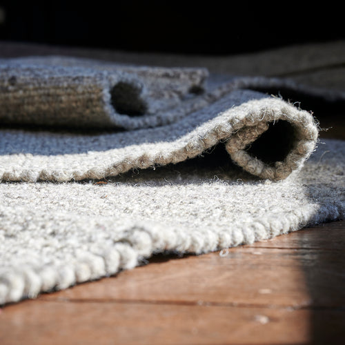 Close-up of the Herdwick and Texel wool rug in shades of grey. 