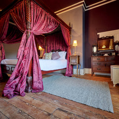 medium wool rug in bedroom thumbnail