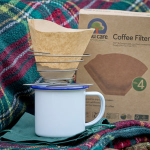 portable wire coffee dripper with coffee filter paper and enamel mug and tartan picnic rug