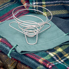 Portable wire coffee dripper on top of green organic cotton carry pouch