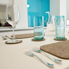 Chimney Sheep Lakeland collection grey wool felted tablemat and coasters on white countertop. Zoomed in on grey tablemat. thumbnail