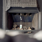 Chimney Sheep handle and safety tag hanging in a fireplace.