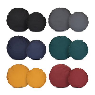 A blue roan cocker spaniel lying comfortably in a sustainable, grey wool felted high side round dog bed. The bed also has a yellow cushion in it which is also filled with sheep's wool.