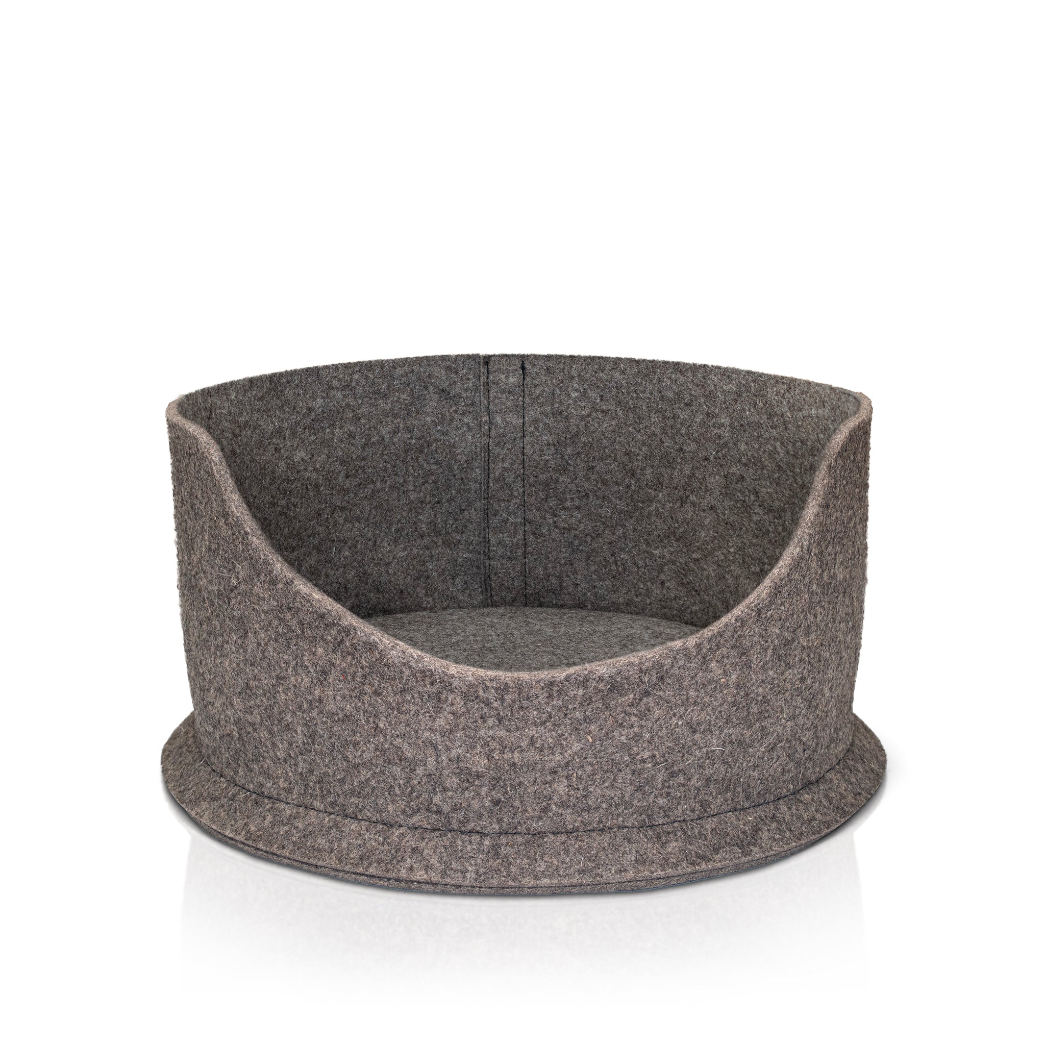 A Chimney Sheep small PetSnug Cat Bed. This is a wool felt cat cozy bed, made of 100% natural sheep's wool. It is plastic free and pet safe. The pet sis upon a white background. It is 3D circular in shape with a dip in the centre to allow easy access for cats.