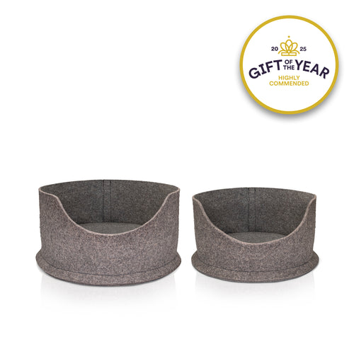 White cat lying in a grey felt pet bed with a 'Gift of the Year Highly Commended' badge.