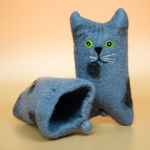 A hoomans friends felted wool natural cat toy placed on an orange background
