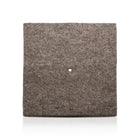 Plastic-free grey wool mulch mat.