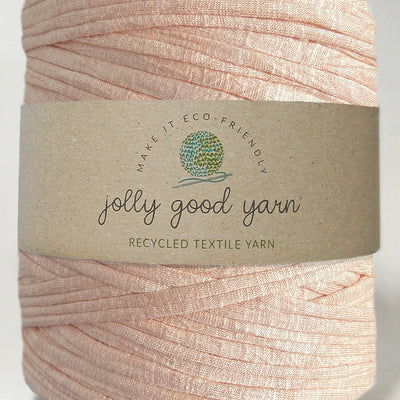 Red yarn ball with a beige label on a white background