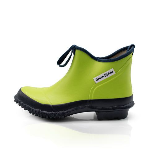 Pair of green rubber boots with black soles on a white background