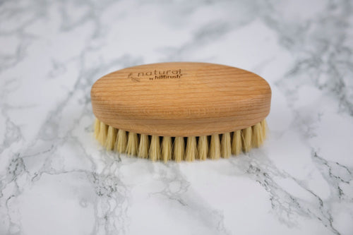 FSC and natural bristle vegetable scrubbing brush on marble background
