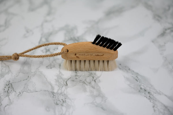 keyboard brush made of FSC wood and natural bristles on marble background
 